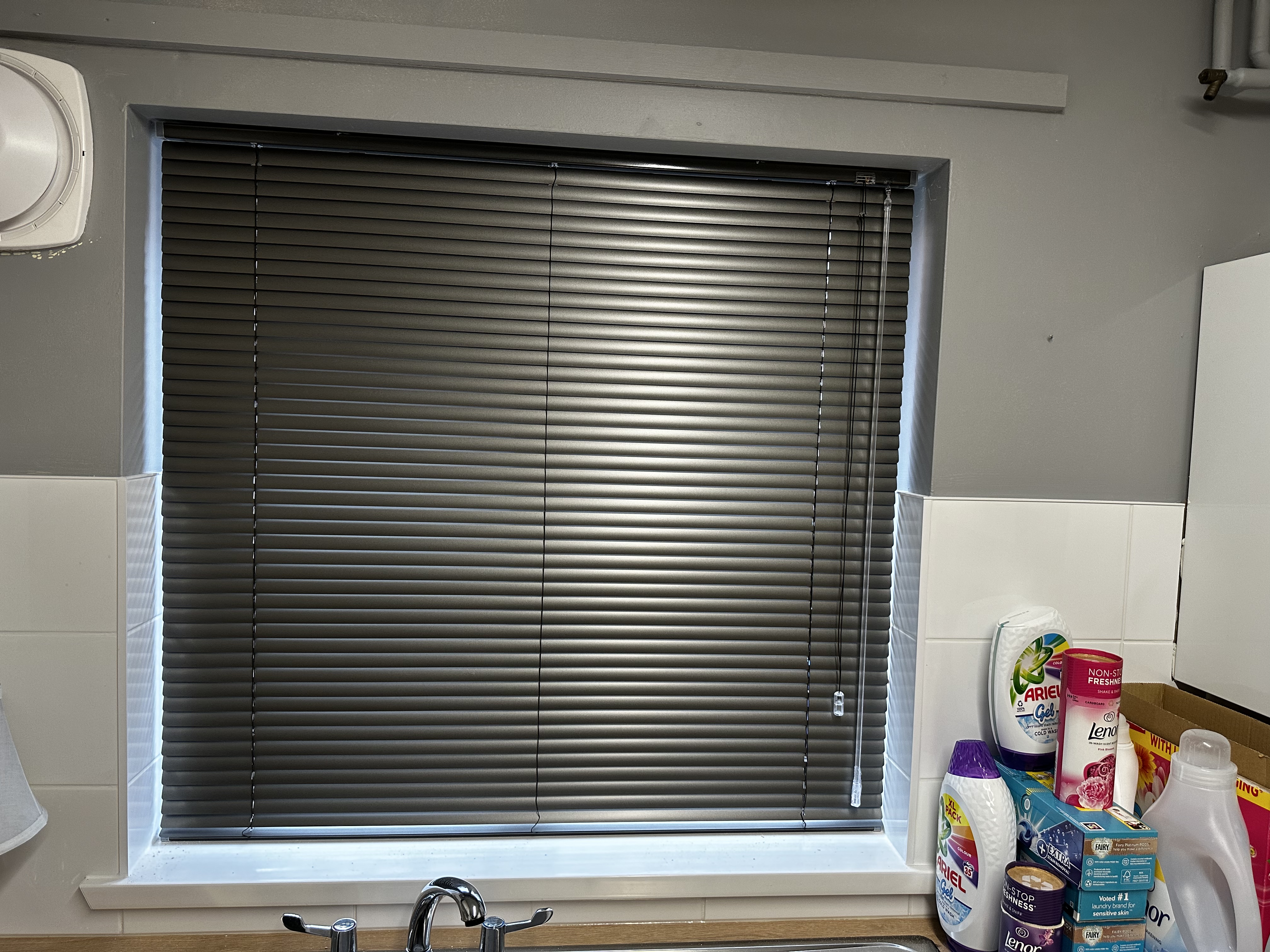 Anthracite grey aluminium venetian blind fitted to a kitchen window